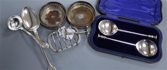 A cased pair of Edwardian seal top spoons, Sheffield, 1908, a Georgian Scottish silver sauce ladle, a silver toastrack etc.